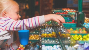 The Emporium at House of Marbles. Young child picking marbles.